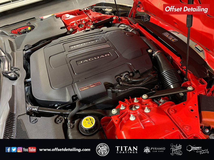 A close up of an engine bay valet on this red F Type S completed with a two stage machine polish and ceramic coating